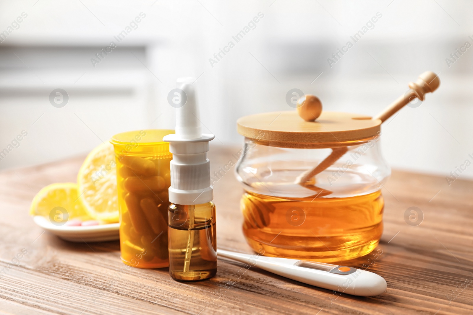 Photo of Natural and medical cold remedies with thermometer on table