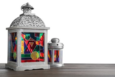 Photo of Decorative Arabic lanterns on wooden table against white background