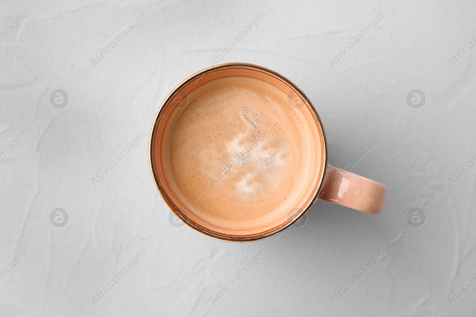 Photo of Cup of aromatic hot coffee on light background, top view