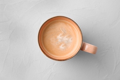 Photo of Cup of aromatic hot coffee on light background, top view