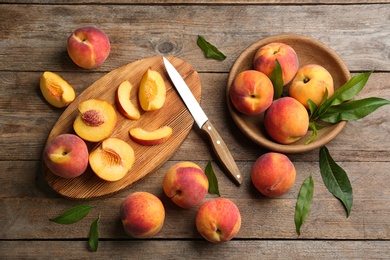 Photo of Flat lay composition with fresh sweet peaches on wooden table