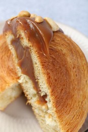 Supreme croissant with chocolate paste and nuts on grey table, closeup. Tasty puff pastry