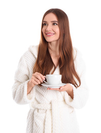 Young woman in bathrobe with cup of drink on white background