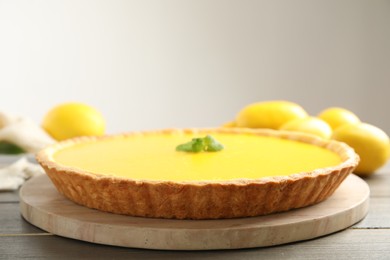 Photo of Delicious homemade lemon pie on wooden table