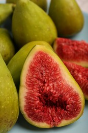 Half of green fig and fresh fruits on table, closeup