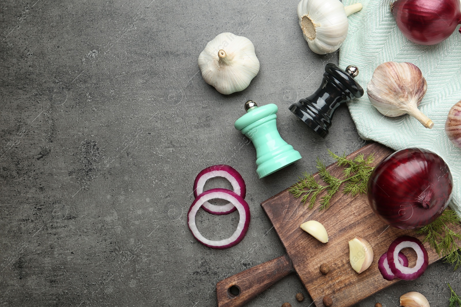 Photo of Flat lay composition with garlic, onions and space for text on grey background