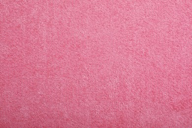 Pink microfiber cloth as background, top view