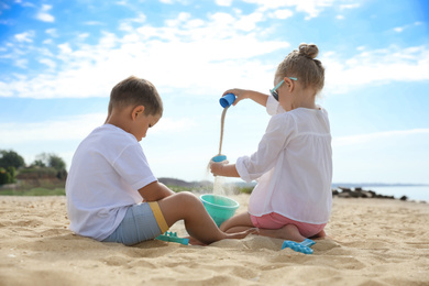 Little children playing on sea beach outside