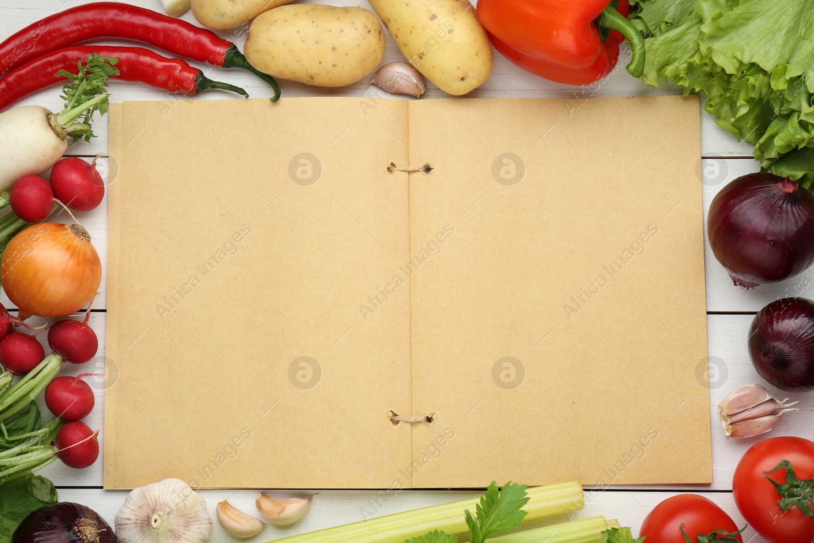 Photo of Blank recipe book and different ingredients on white wooden table, flat lay. Space for text