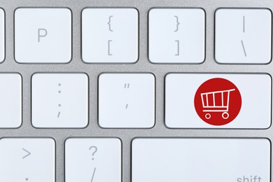 Online store. Button with shopping cart on computer keyboard, top view