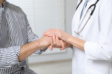 Photo of Patient having appointment with doctor in clinic, closeup