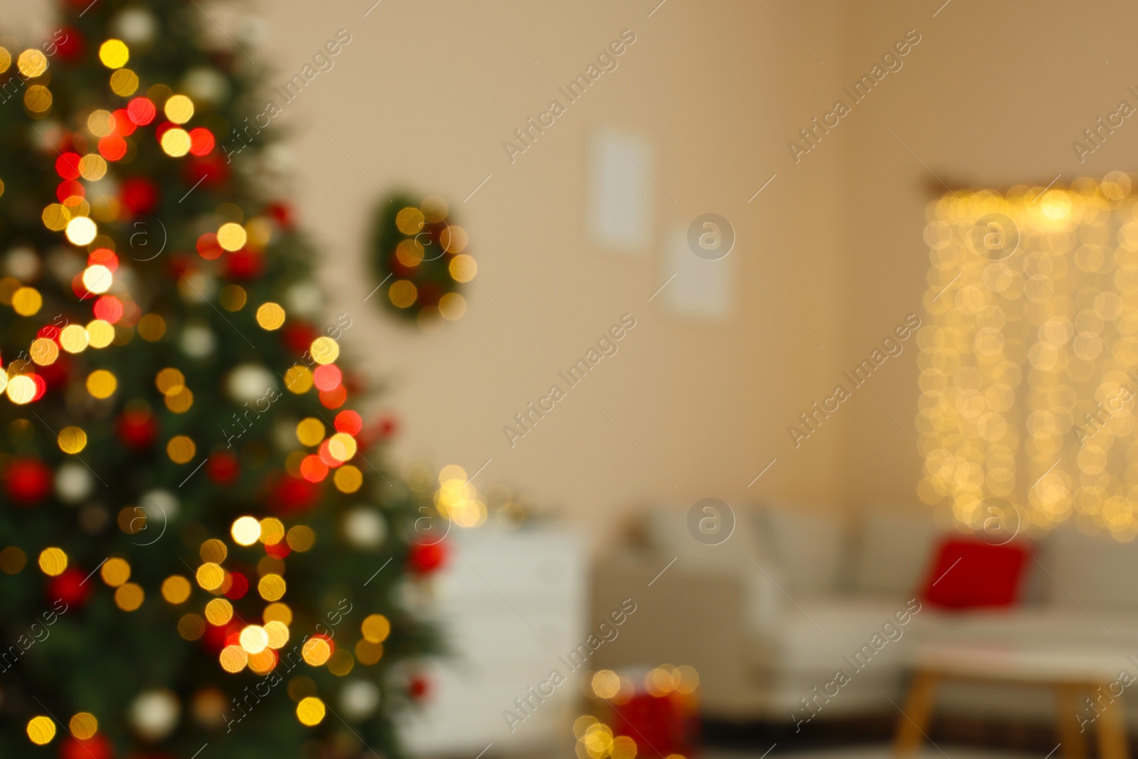 Photo of Blurred view of beautiful Christmas tree decorated with festive lights in stylish room. Interior design