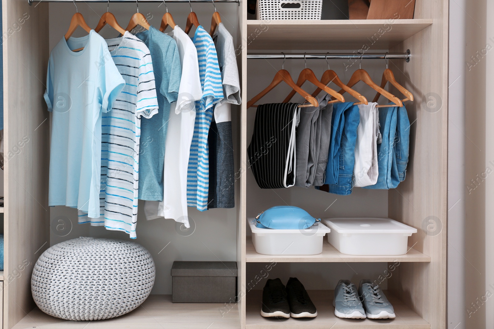 Photo of Stylish clothes, shoes and home stuff in large wardrobe closet