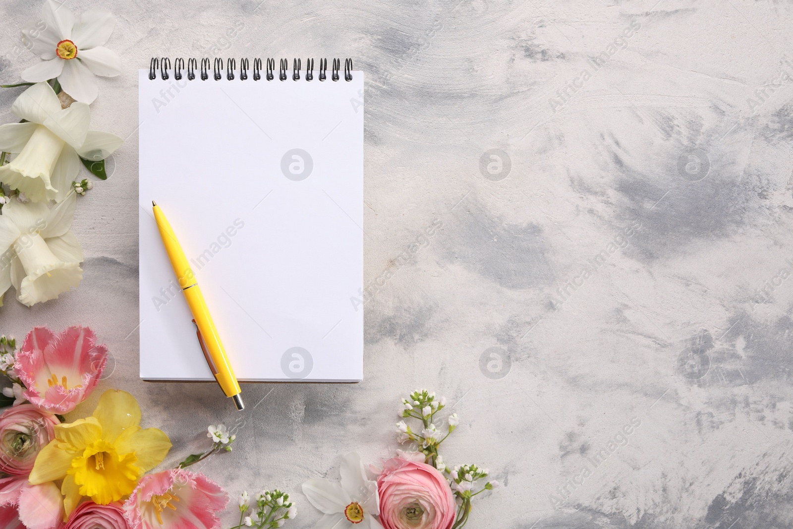 Photo of Guest list. Notebook, pen and beautiful flowers on gray textured background, flat lay. Space for text