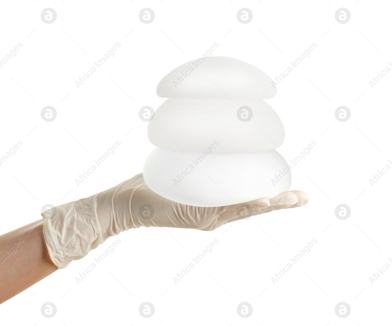 Photo of Doctor holding silicone implants for breast augmentation on white background. Cosmetic surgery