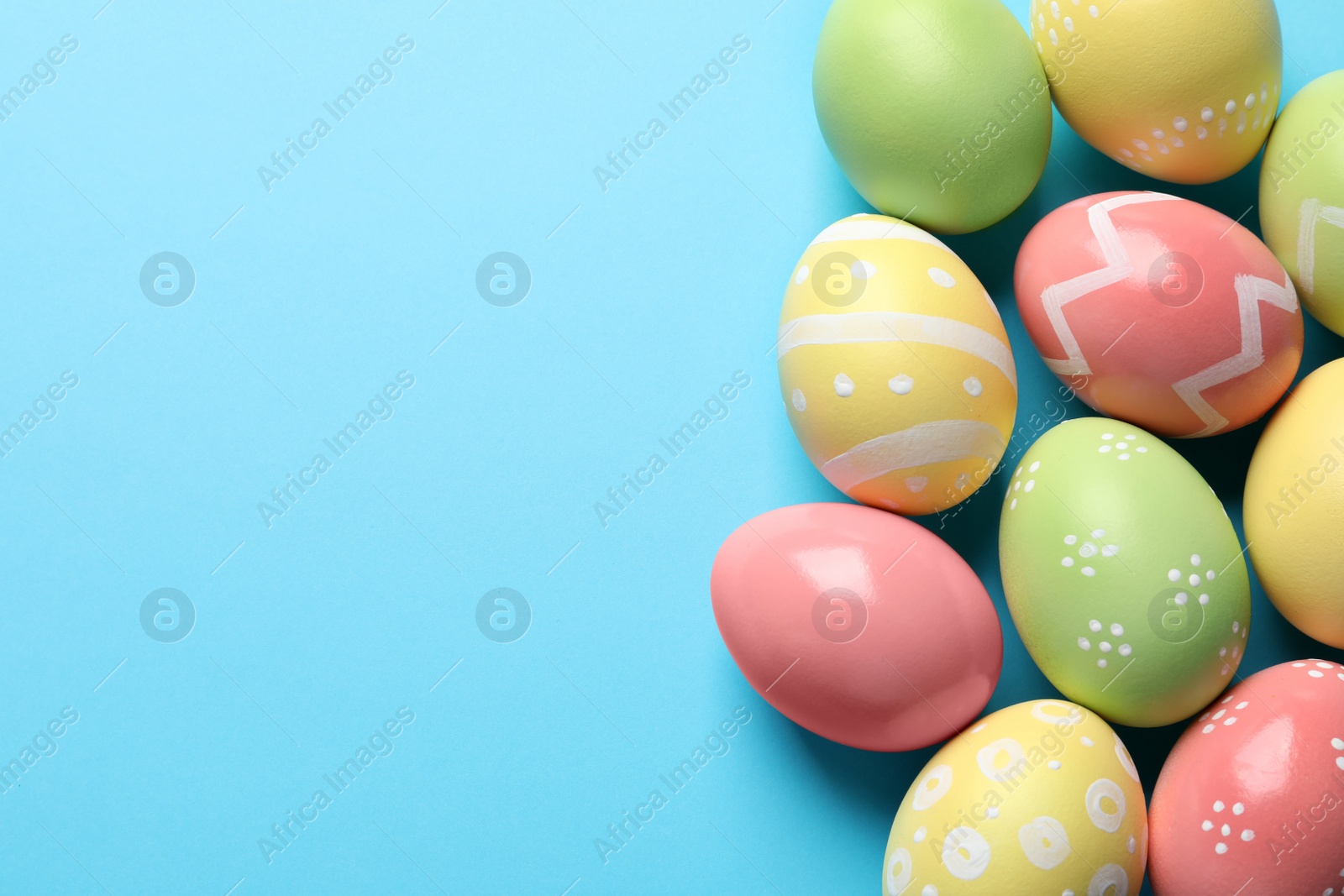 Photo of Beautiful painted Easter eggs on color background, flat lay. Space for text