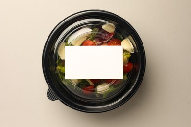 Tasty food in container on light background, top view. Space for text