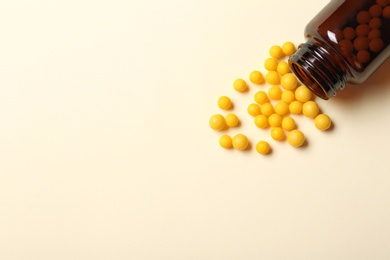 Photo of Bottle with vitamin pills on color background, flat lay. Space for text