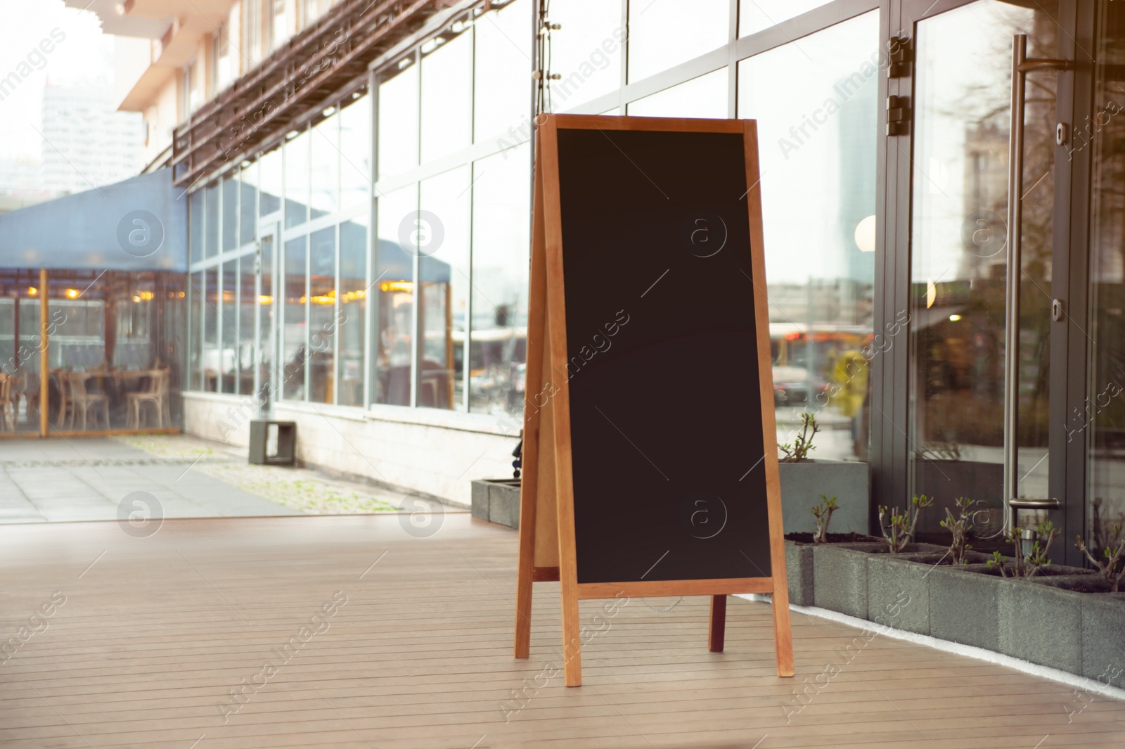 Photo of Empty A-board near building outdoors. Mockup for design