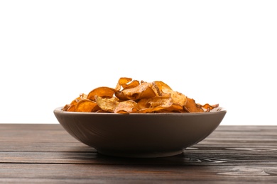 Photo of Plate of sweet potato chips on table against white background. Space for text