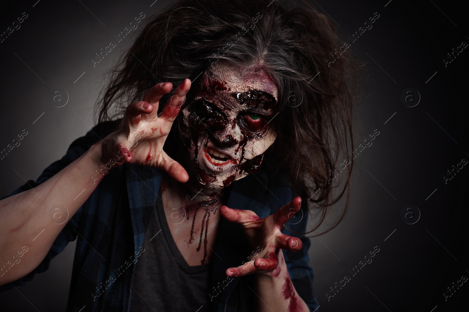 Photo of Scary zombie on dark background. Halloween monster