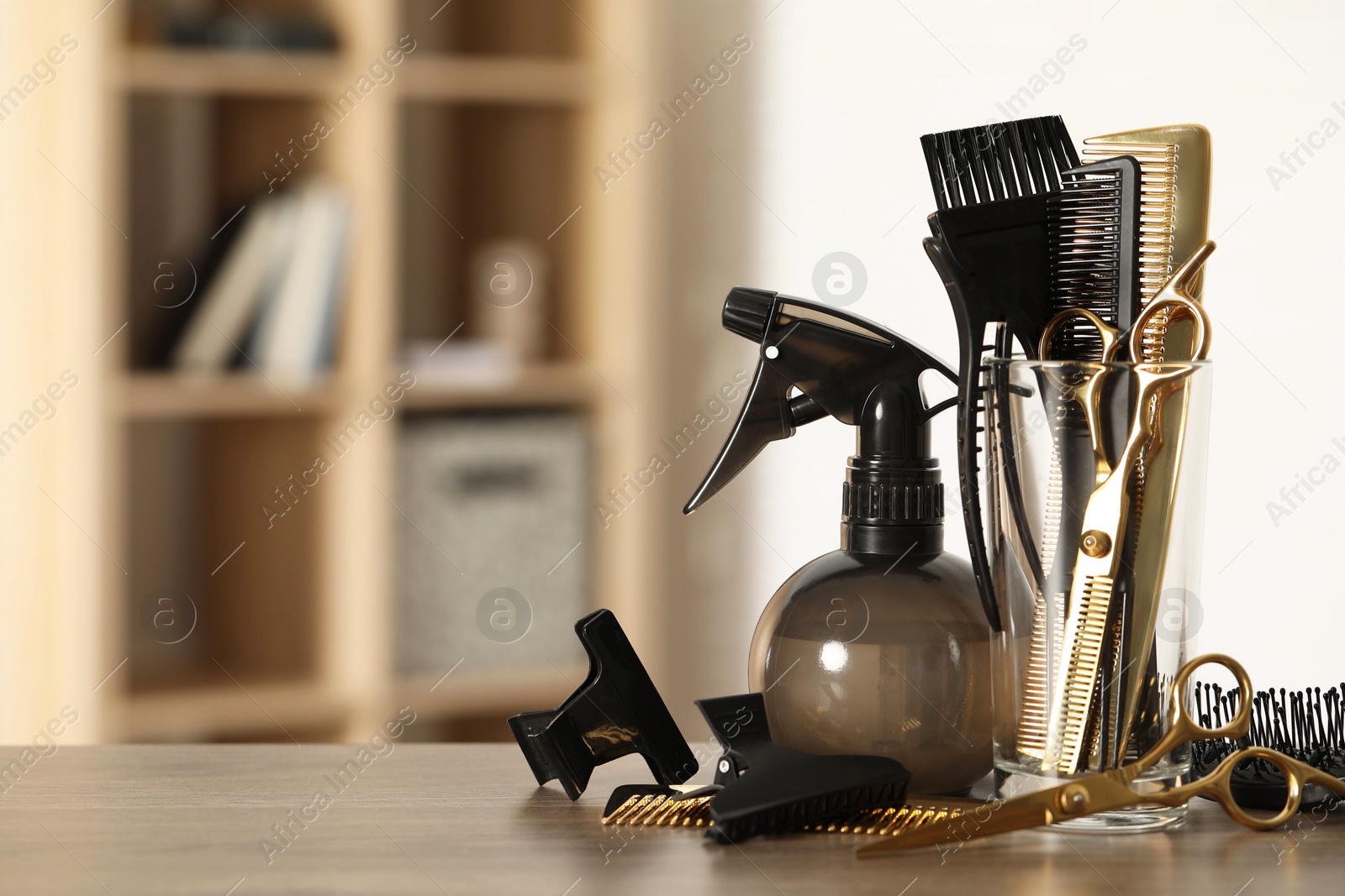 Photo of Set of hairdresser tools on table in salon, space for text