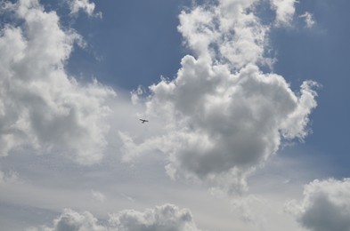 Photo of Modern airplane flying in sky with clouds