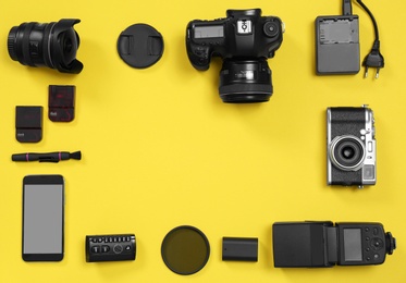 Flat lay composition with professional photographer equipment and space for text on color background