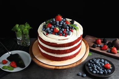 Photo of Composition with delicious homemade red velvet cake on table