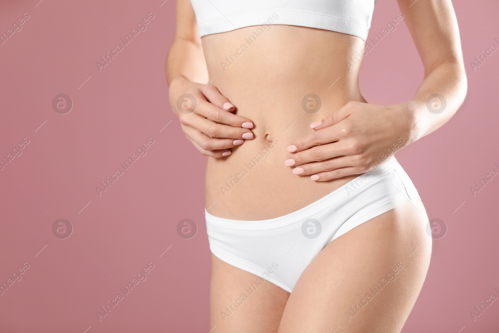 Photo of Young woman showing smooth silky skin after epilation on color background