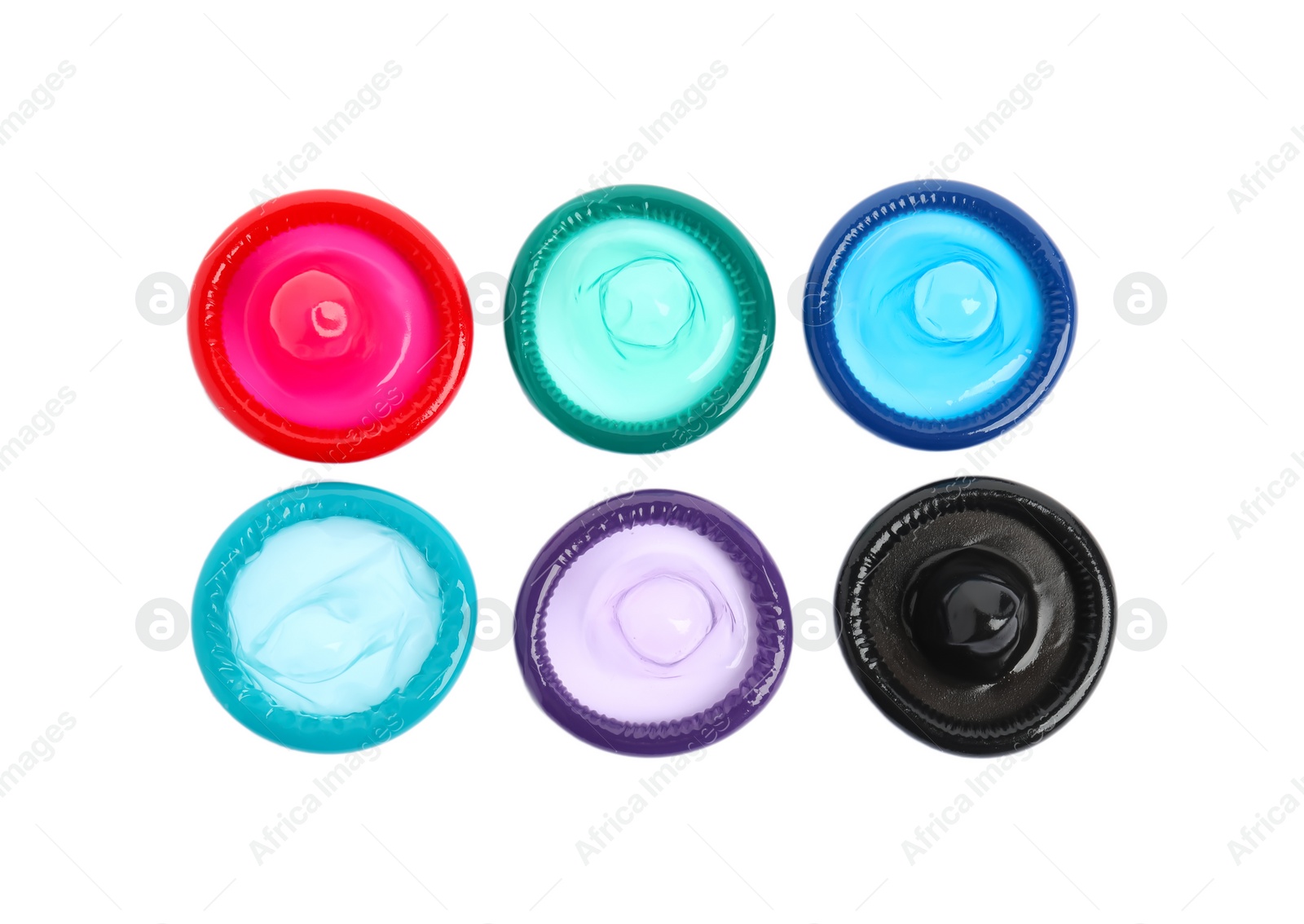 Photo of Unpacked colorful condoms on white background, top view. Safe sex