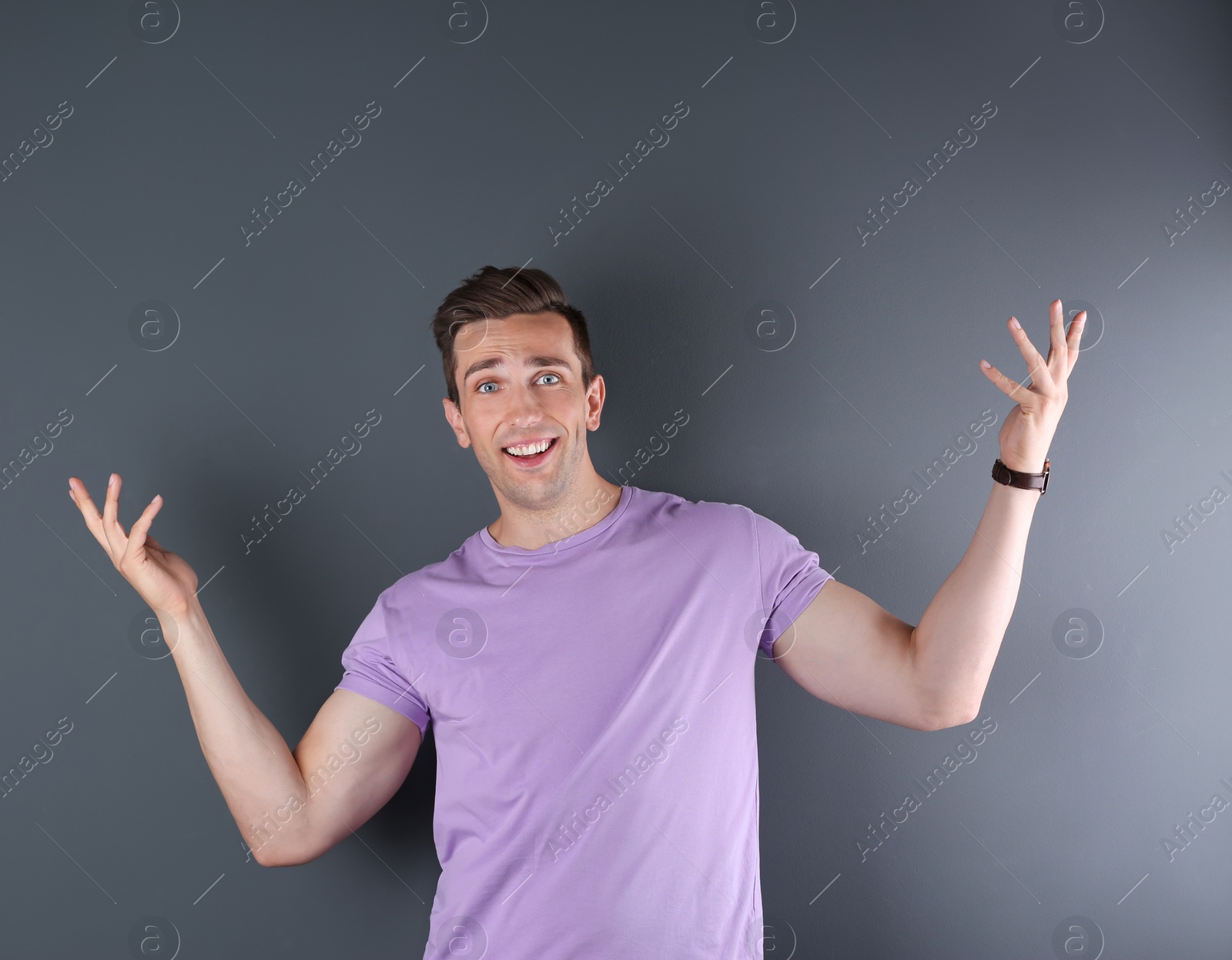 Photo of Handsome emotional young man on color background