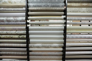 Photo of Assortment of stylish wall papers on display in shop