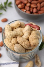 Photo of Fresh unpeeled peanuts on grey table, closeup