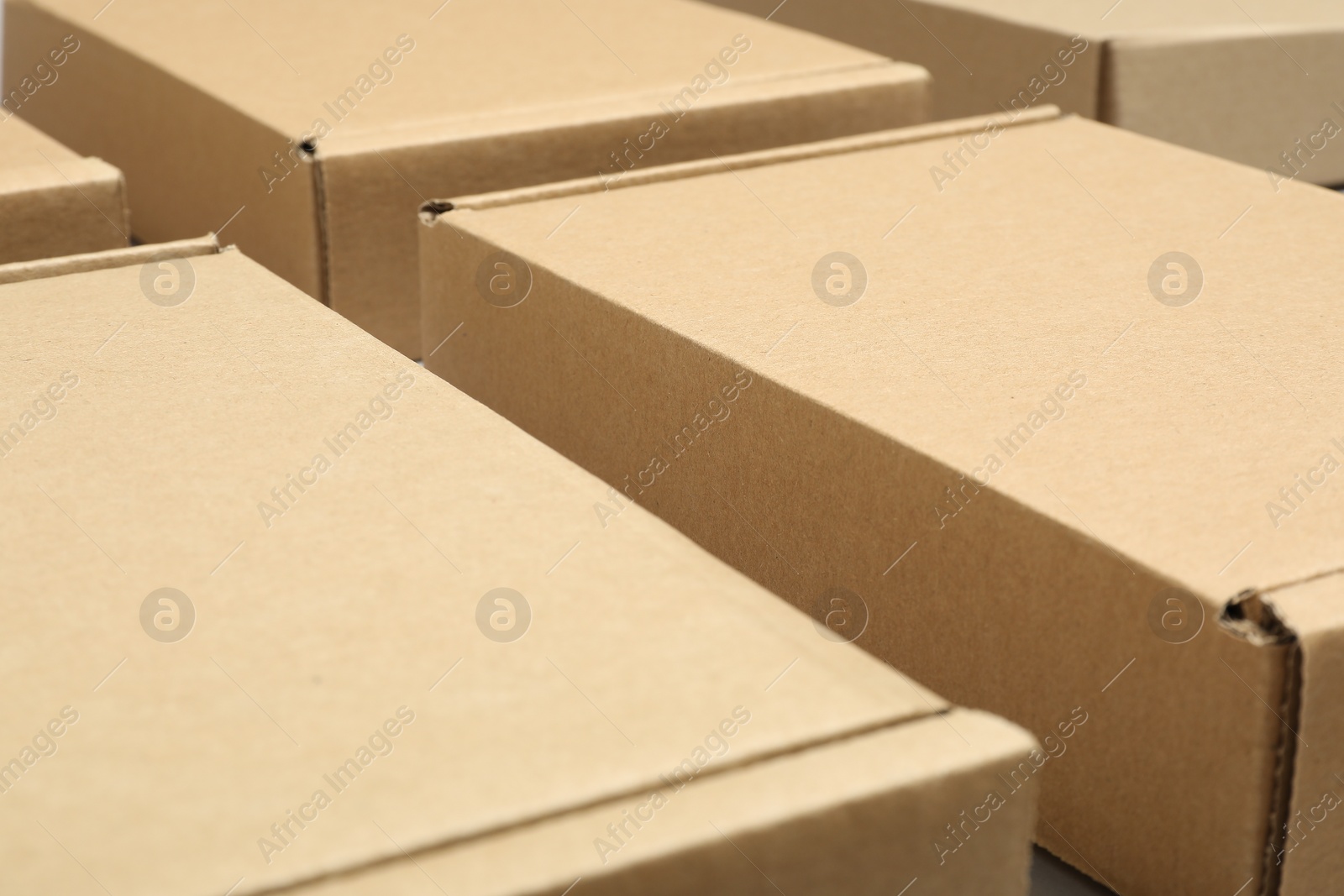 Photo of Many cardboard boxes, closeup view. Packaging goods