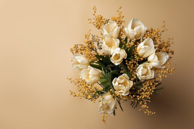 Bouquet with beautiful tulips and mimosa flowers on yellow background, top view. Space for text