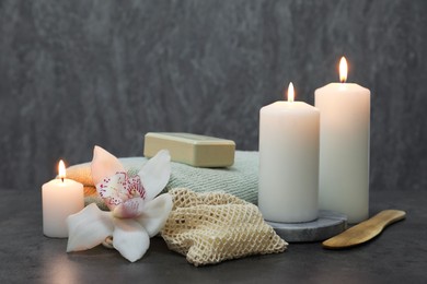 Photo of Composition with different spa products and orchid flower on grey table