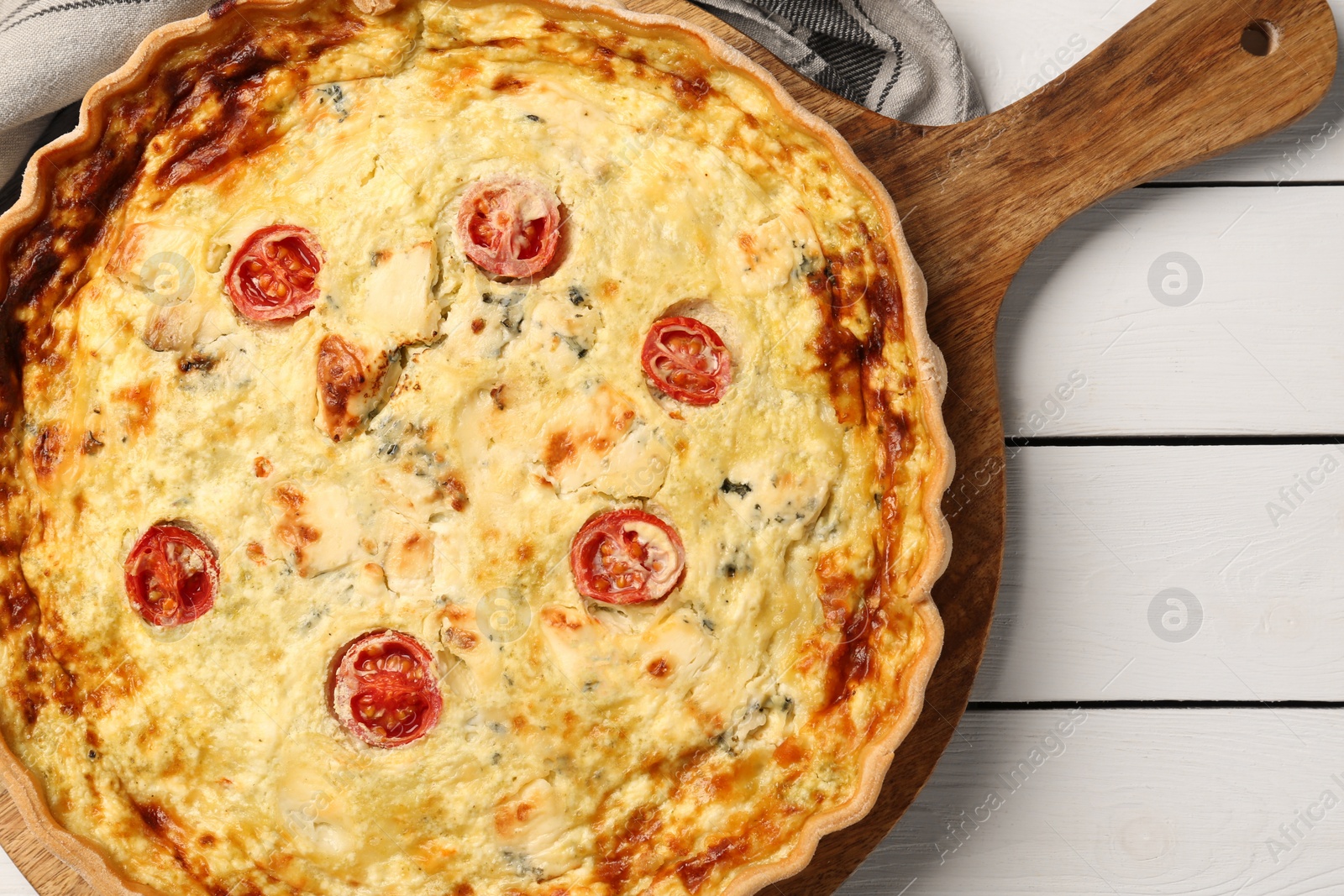 Photo of Delicious homemade cheese quiche on white wooden table, top view