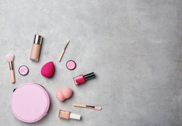 Photo of Flat lay composition with professional makeup products on grey background