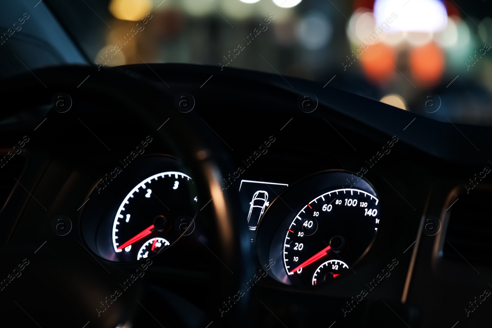 Photo of Closeup view of dashboard with speedometer and tachometer in modern car