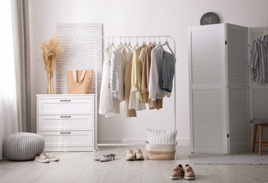 Photo of Dressing room interior with stylish white furniture