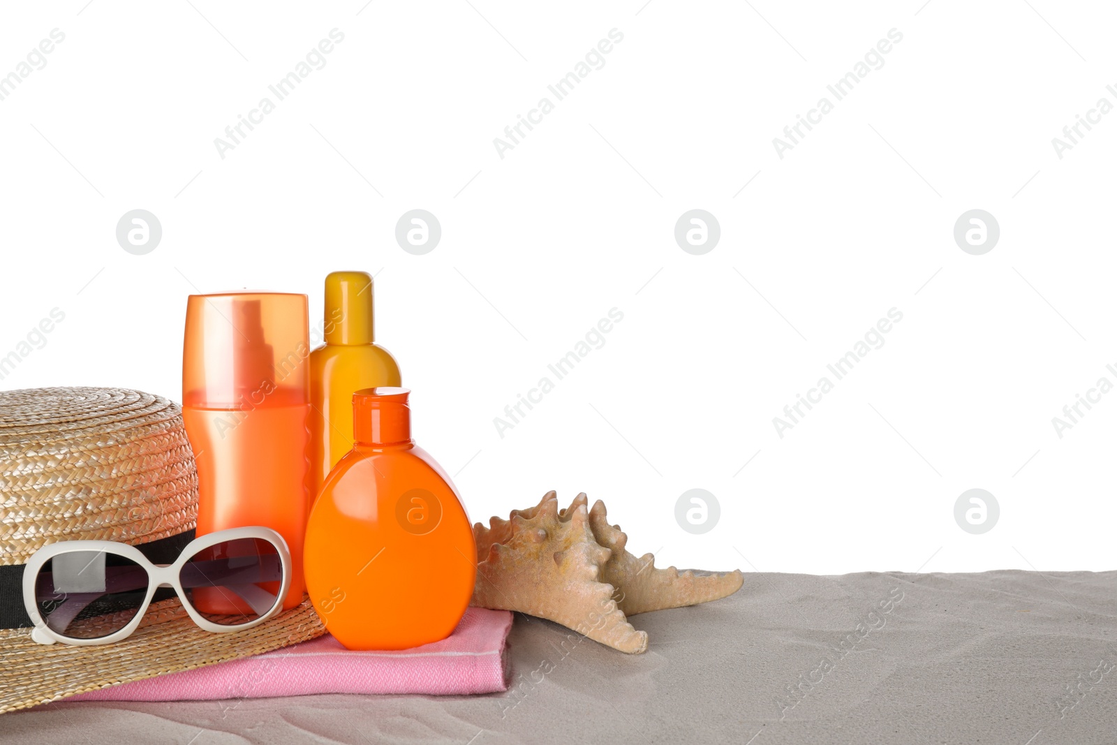 Photo of Composition with sun protection products on sand against white background. Space for text