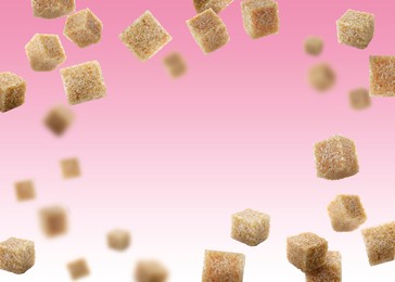 Image of Brown cane sugar cubes falling on pink gradient background