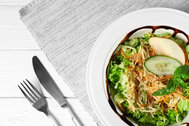 Photo of Plate with delicious fresh salad on table, top view