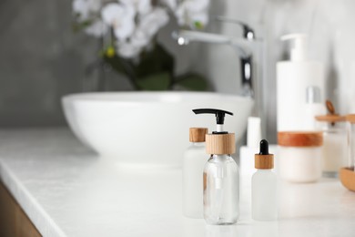 Photo of Different personal care products on countertop in bathroom. Space for text