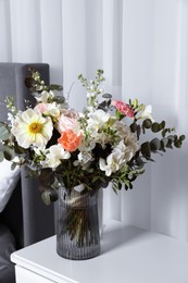 Photo of Bouquet of beautiful flowers on nightstand indoors