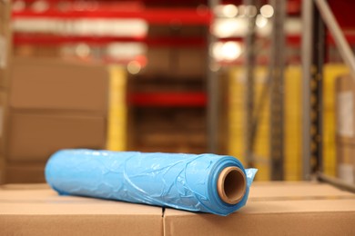 Photo of Roll of stretch wrap on boxes in warehouse