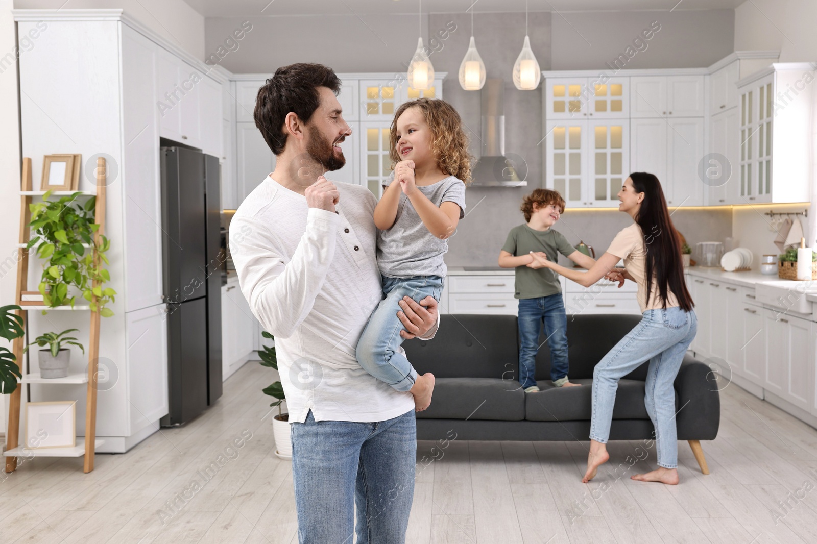 Photo of Happy family dancing and having fun at home