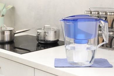 Photo of Water filter jug on white countertop in kitchen