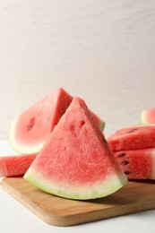 Photo of Delicious fresh watermelon slices on white table